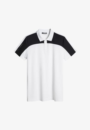 Valkoinen polo-paita mustilla yksityiskohdilla harteilla ja hihoissa. Sisältää kauluksen ja kolme nappia. Sileä, kevyt kangas.