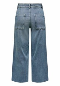 Pantalon en jean bleu à coupe large avec taille haute et grandes poches arrière carrées, vu de dos sur fond blanc.