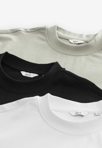 Tre crew-neck t-shirts i sort, hvid og lys grå. Lavet af blød bomuld med syede halsudskæringer og synlige mærkater.