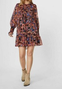 Šaty s květinovým vzorem mají nařasený živůtek, dlouhé průsvitné rukávy a volánkový lem. Látka je lehká; barvy zahrnují oranžovou, modrou a růžovou.