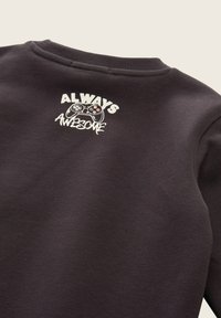Felpa grigia scura con collo rotondo, caratterizzata da una scritta bianca che dice "ALWAYS AWESOME" e una grafica di un controller di gioco sul retro.