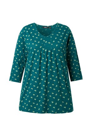 Tunic turchese con scollatura a V e maniche a tre quarti. Presenta un davanti plissettato e un motivo di piccole forme gialle in tutta la superficie.