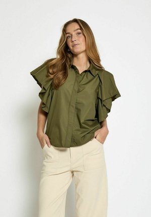 Olive green button-up shirt with ruffled short sleeves, made of a smooth fabric, paired with light cream wide-leg trousers.