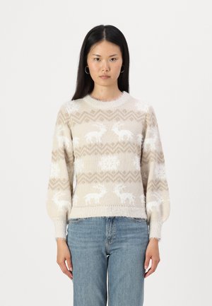Beige knit sweater with a fluffy texture, featuring white reindeer and snowflake patterns. Ribbed round neck and slightly puffed sleeves.