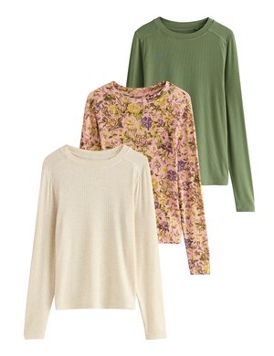 Three long-sleeve tops: one cream, one pink floral pattern with purple and yellow accents, one solid green. All have round necklines and soft texture.