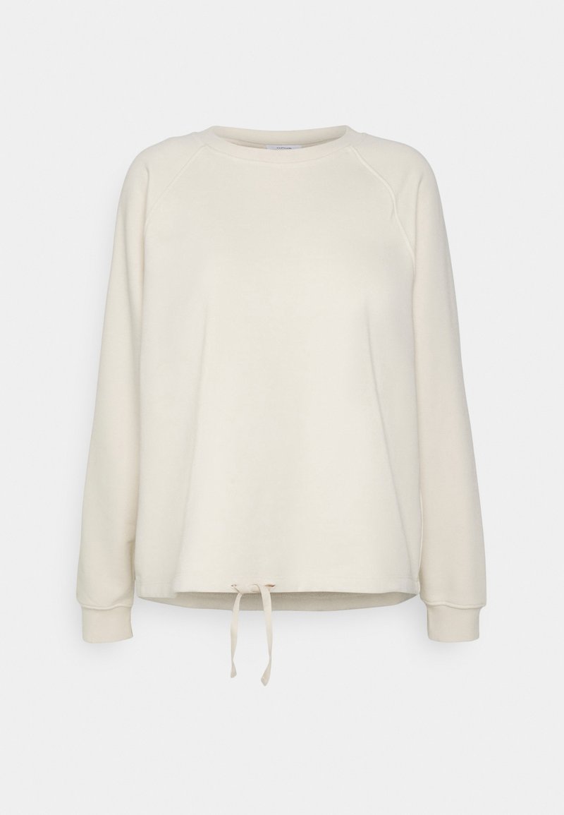 Krémová mikina vyrobená z měkkého materiálu, s kulatým výstřihem, dlouhými raglánovými rukávy a šňůrkovým lemem.