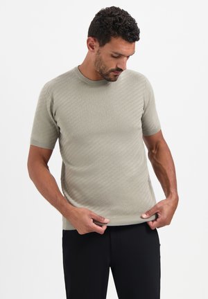 Kurzärmliges, geripptes Strick-T-Shirt in Hellgrün. Hat einen Rundhalsausschnitt und eine taillierte Silhouette mit subtiler Textur.