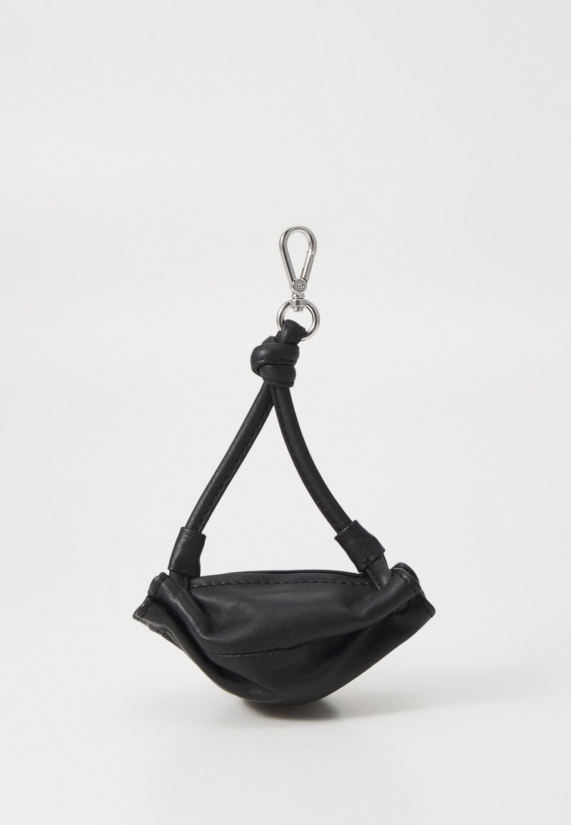 Black leather pouch with a curved shape, featuring a knotted strap and a silver metal clip for attachment. Smooth texture, minimal design.