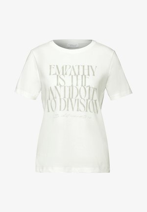 Camiseta de algodón blanca con un gran texto gris que dice "LA EMPATÍA ES EL ANTÍDOTO A LA DIVISIÓN" y texto adicional pequeño debajo.