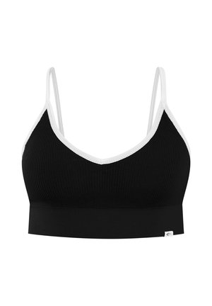 Bralette noire côtelée avec bordure blanche, fines bretelles réglables et petite étiquette de marque blanche en bas à gauche.