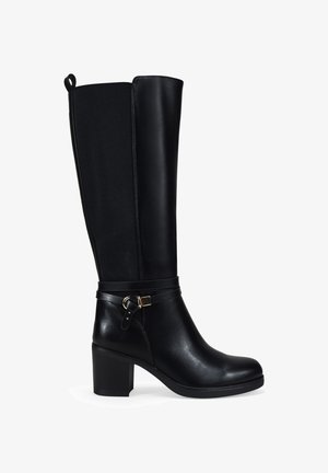 Black knee-high leather boot with block heel, elastic back panel, and decorative strap with gold buckle around ankle.
