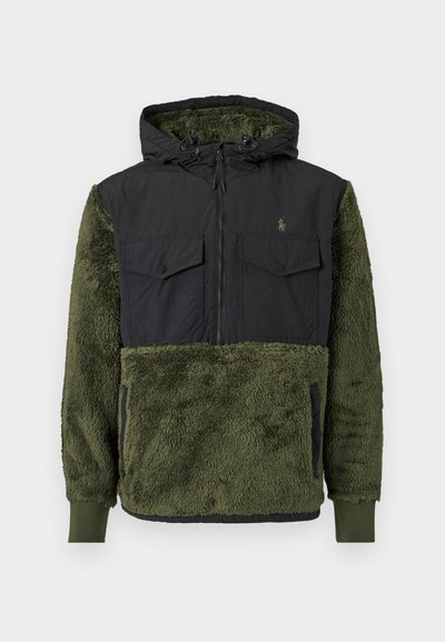 Casaco com capuz apresentando uma parte superior preta e uma parte inferior de lã texturada verde. Inclui bolsos frontais e fecho com zíper.