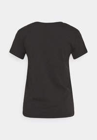 T-shirt noir uni à manches courtes, vu de dos avec un col rond sur un fond gris clair.