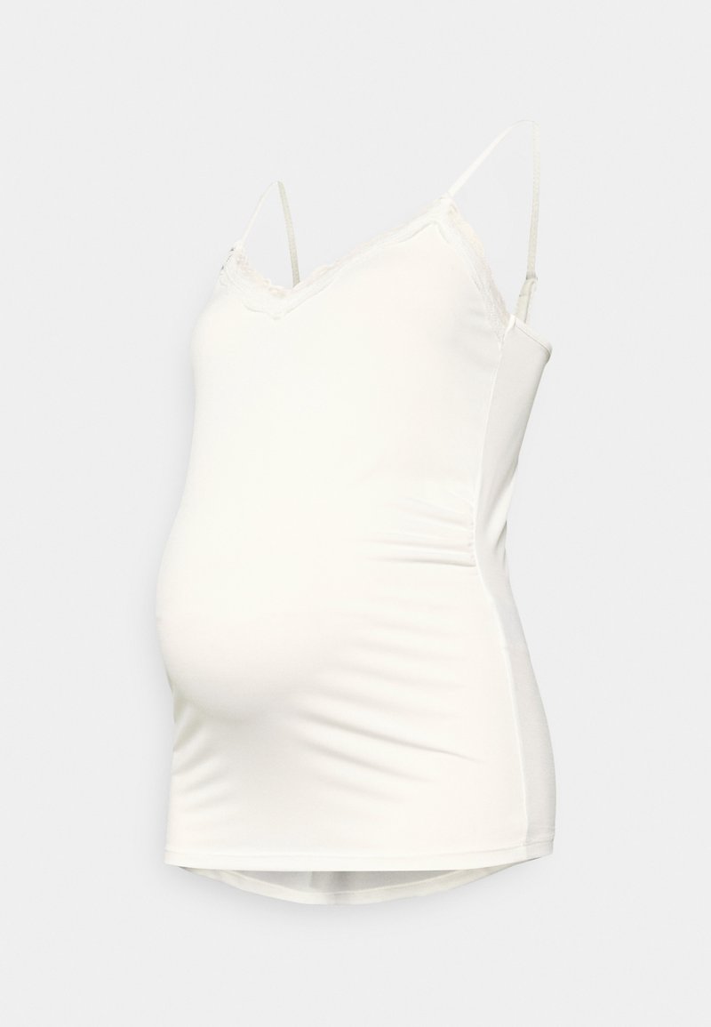 Top bianco per gravidanza con spalline regolabili, pizzo lungo il collo e una silhouette aderente che si adatta a una pancia in crescita.