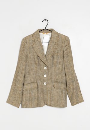 Beige plaid blazer with three white buttons, notch lapel collar, two flap pockets, hanging on black hanger with white tag inside.