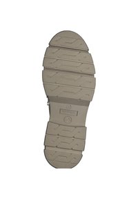 Licht beige rubberen buitenzool met een gestructureerd patroon, met diepe loopgroeven voor grip en een soepele afgeronde neus.