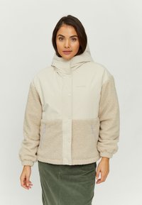 Beige jacket with a fluffy, textured lower half, a smooth upper section, a hood, and purple zipper accents. Brand name "MAZINE" visible.