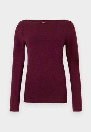 Long-sleeve, crew neck women's top in solid deep burgundy, made of smooth, fitted fabric.