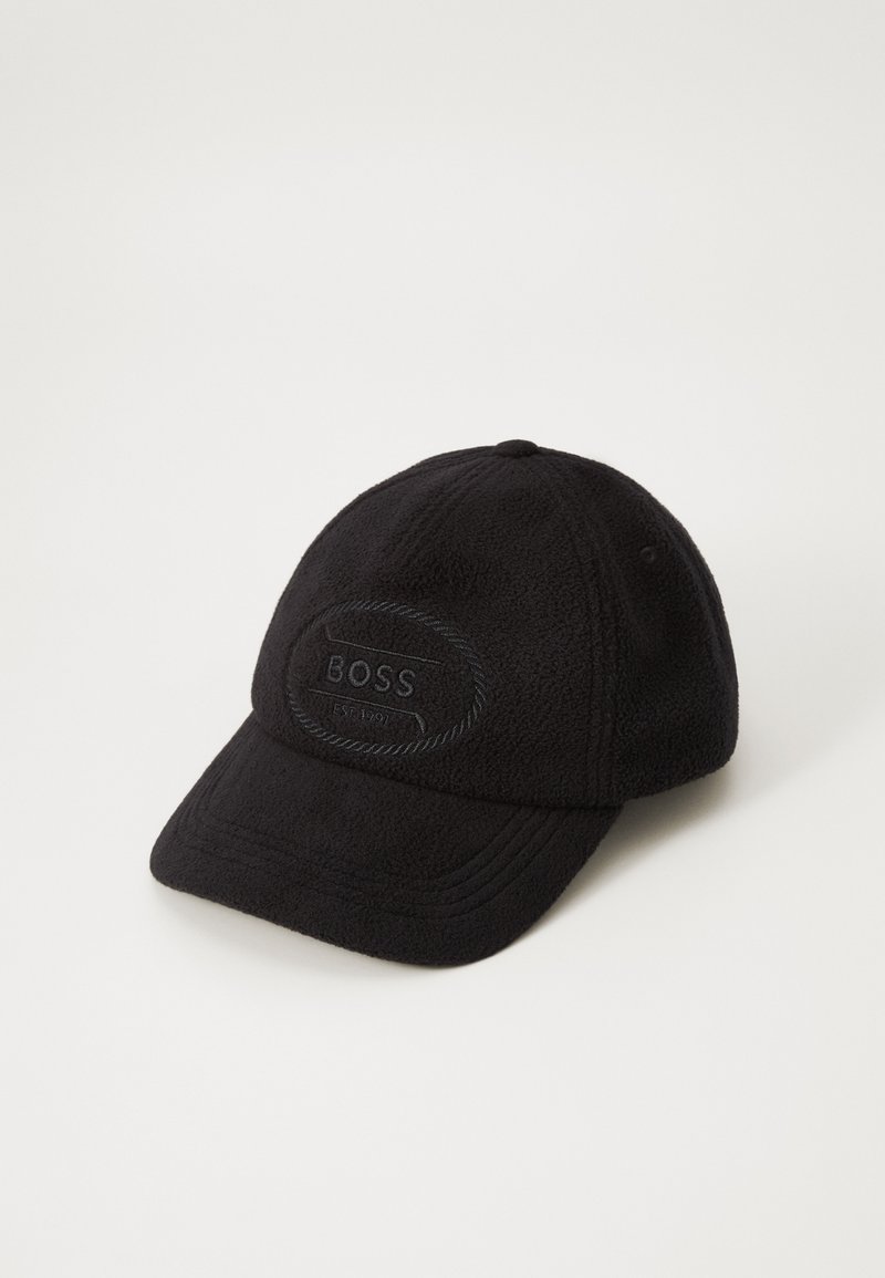 Black cap made of soft fleece material, featuring a textured badge with "BOSS" and rope detailing, curved brim, and embroidered accents.