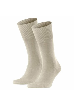 Beige Baumwollsocken mit geripptem Bündchen, nahtloser Spitze und glatter Textur; entworfen für Komfort und Langlebigkeit.