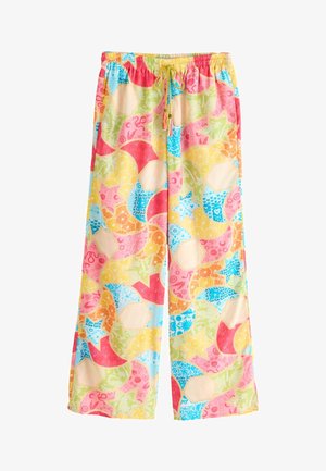 Weit geschnittene Hose mit elastischem Bund und bunten abstrakten Mustern mit Sternen, Fruchtscheiben und floralen Designs in Pastellfarben.