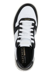 Black and white Skechers sneakers with leather upper, perforated toe, white laces, and gold accents on the branding and insole.