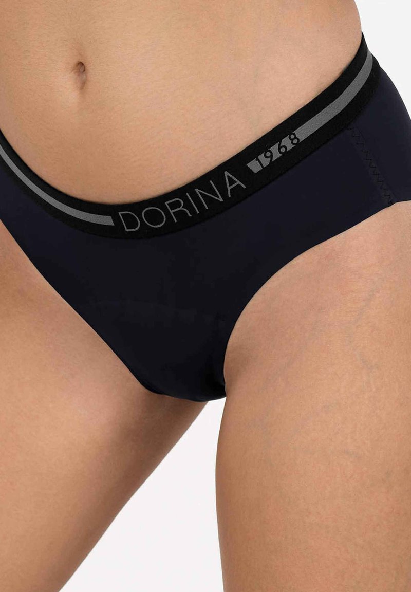 Melni bikini apakšbikses ar gludu tekstūru, kurām ir mīksts jostasvieta, izcelta ar pelēku logo un gadu "1968".