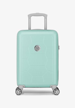 Harde koffer in mintgroen met een hexagonaal patroon, zilverkleurige hardware, uitschuifbare handgreep en vier wielen voor mobiliteit.