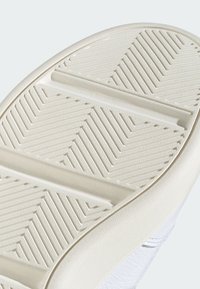 Gumeni đon s c textured uzorkom koji sadrži dijagonalne utore i žljebove. Svijetla krem boja s glatkim rubovima i minimalnim detaljima.