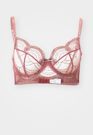 Lace bh in rozenkleur met doorzichtige panelen, gegolfde randen, decoratieve stiksels en een centrale strikdetail. Verstelbare bandjes inbegrepen.