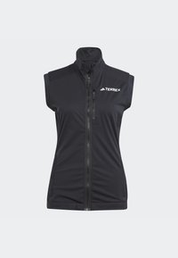 Black sleeveless vest made from a soft, stretchy material; features a high collar and a front zipper; logo printed on the upper left.