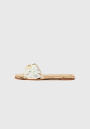 Tongs à motif floral avec une base crème, des accents en métal doré, une semelle plate et une texture douce.