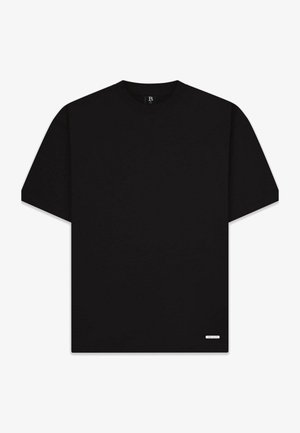 T-shirt en coton noir à manches courtes, décolleté rond et logo discret sur l'ourlet inférieur. Couleur unie, texture lisse.