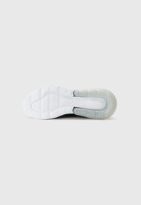 Semelle d'une chaussure de sport avec un motif blanc et une partie de talon transparente et rembourrée sur un fond uni gris clair.