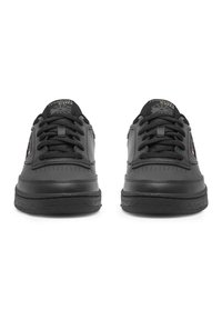 Juodi odiniai sportbačiai su apvalia nosimi, tekstūruota pada, juodais raišteliais ir subtiliu prekės ženklu ant liežuvėlio bei šono. Lygūs ir perforuoti detalės.