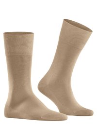 Calze beige al ginocchio con polsini a coste, texture liscia e design semplice, adatte per l'uso quotidiano.