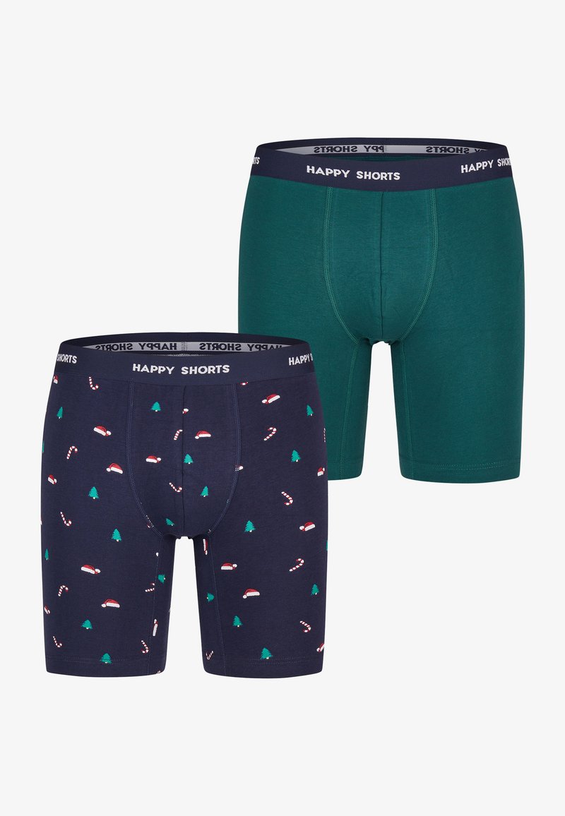 Twee pakken herenboxers; één in effen groen en één in marineblauw met feestelijke patronen van kerstmannenhoeden en zuurstokken. Tailleband met het label "HAPPY SHORTS."