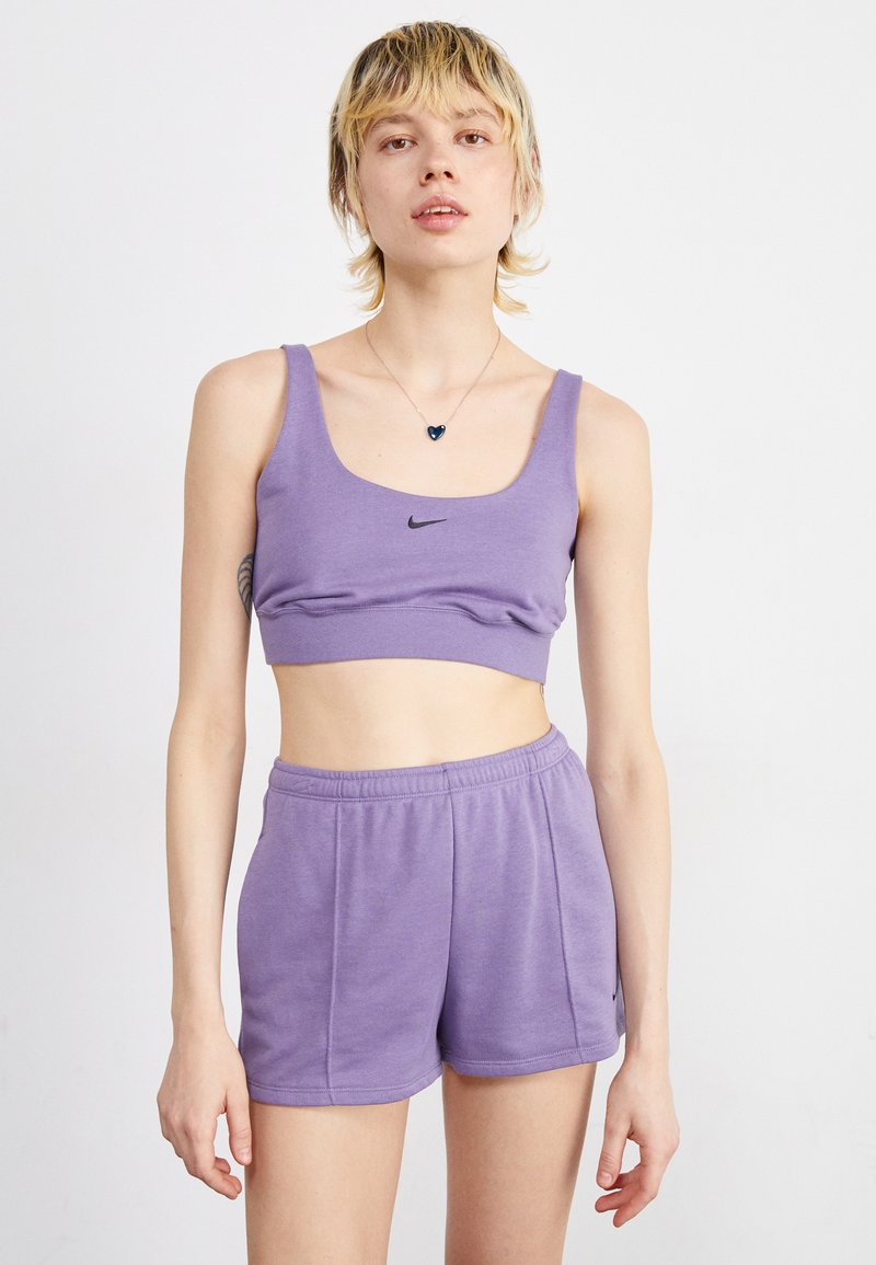 Purple athletic crop top with a black Nike logo, paired with matching purple shorts. Both are made of soft, smooth fabric.