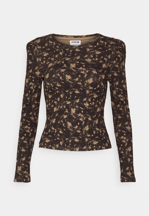 Haut à manches longues noir et beige en ribbed avec un motif de taches abstrait et des épaules légèrement bouffantes.