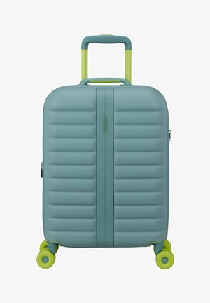 Valise rigide turquoise avec des rainures horizontales, poignée télescopique vert citron et quatre roulettes vert citron.