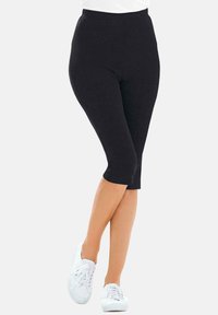 Zwarte capri leggings van rekbaar materiaal, met een elastische tailleband, aansluitende pasvorm en een gladde oppervlakte structuur.