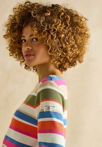 Multicolored striped sweater in cotton, featuring green, pink, blue, and orange stripes. Includes a label patch on the left sleeve.