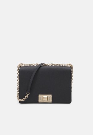Schwarze Leder-Schultertasche mit goldener Kettenriemen und rechteckigem goldenenverschluss auf der Vorderseite vor weißem Hintergrund.