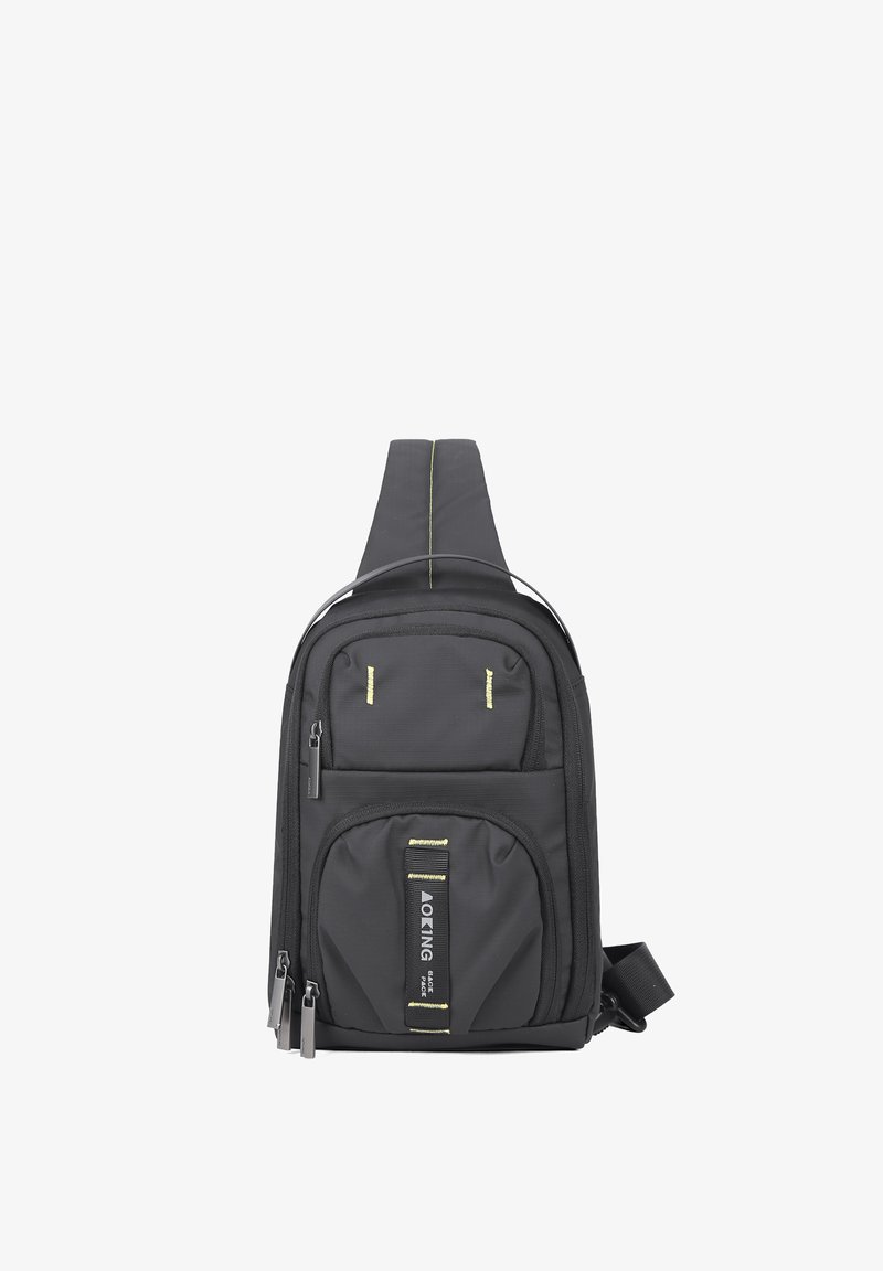 Borsa a tracolla nera con una finitura testurizzata, che presenta molteplici tasche con zip, una cinghia frontale e accenti riflettenti gialli.