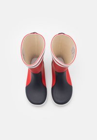 Red and navy rubber rain boots with a smooth texture, rounded toe, and white accent stripes at the top edge. Interior is beige.