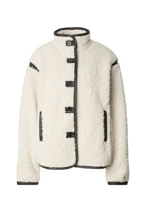 Kremfarget shearlingjakke med stående krage, fem knappelukkinger, og svart skinnkant langs kanter og lommer.