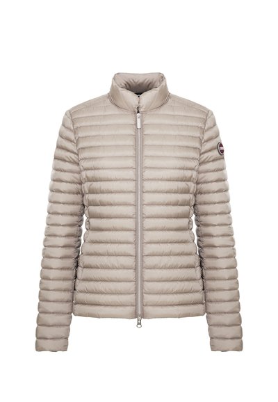 Veste matelassée beige clair avec fermeture éclair intégrale à l'avant et col montant, avec un patch logo rond sur la manche supérieure gauche.