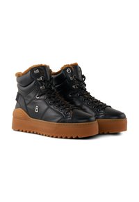 Schwarze Leder-Hightop-Sneaker mit dicken braunen Gummisohlen, fellgefüttert, mit metallenen Ösen und Schnürsenkeln, nebeneinander auf weißem Hintergrund dargestellt.
