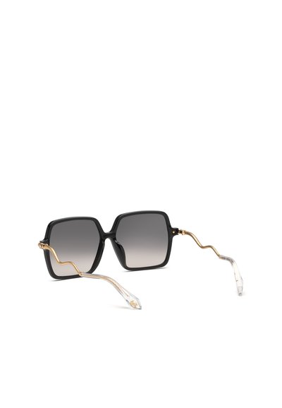Lunettes de soleil carrées noires avec verres foncés en dégradé et branches dorées en forme de serpent terminant par des embouts en plastique transparent.