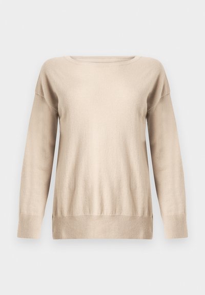 Bēšs džemperis no mīksta adīta materiāla ar apaļu kakla izgriezumu, garām piedurknēm un vaļīgu piegriezumu ar ribotiem aproču un apakšmalas galiem.